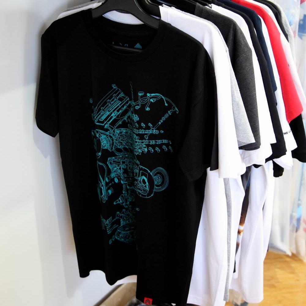 Level UP Nissan RB26 engine diagram T-shirt in black hung up on a rack in a JDM wares retail store
