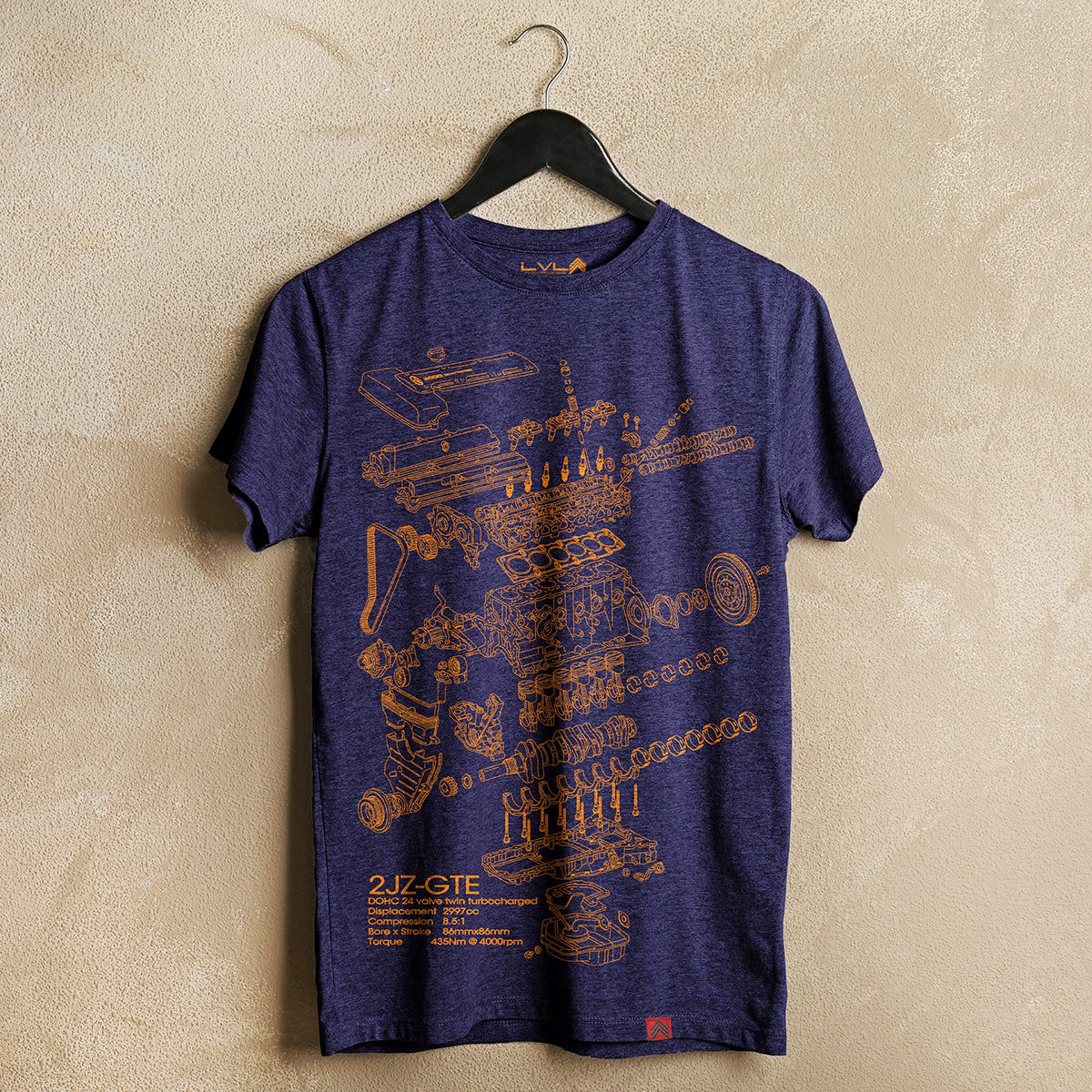 Level UP Toyota 2JZ engine diagram T-shirt in navy blue hung on a neutral wall by a coat-hanger displaying its screen printed art