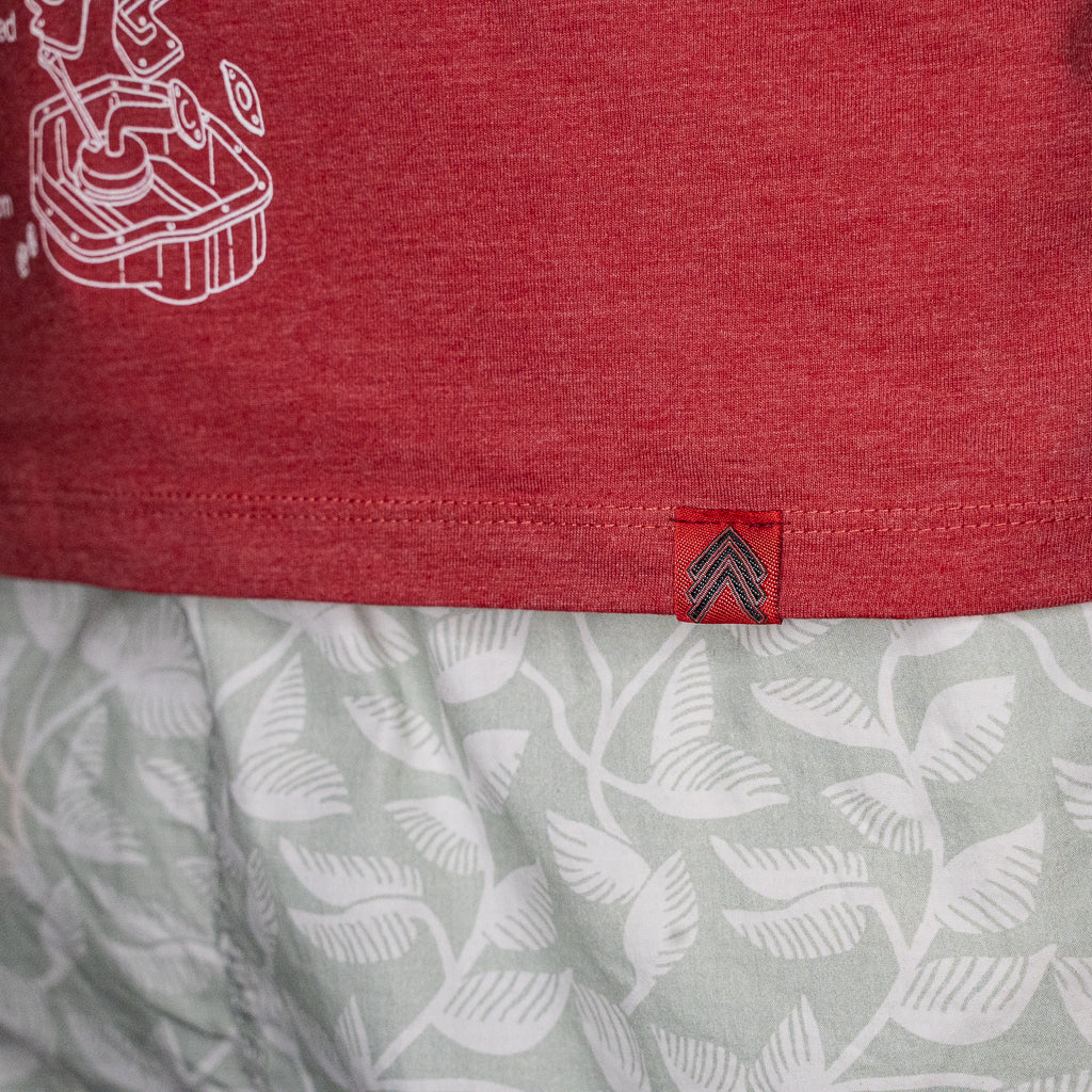 Close up of Level UP Toyota 2JZ engine diagram T-shirt in red focusing on red Level UP tag sewn into the hem of the garment