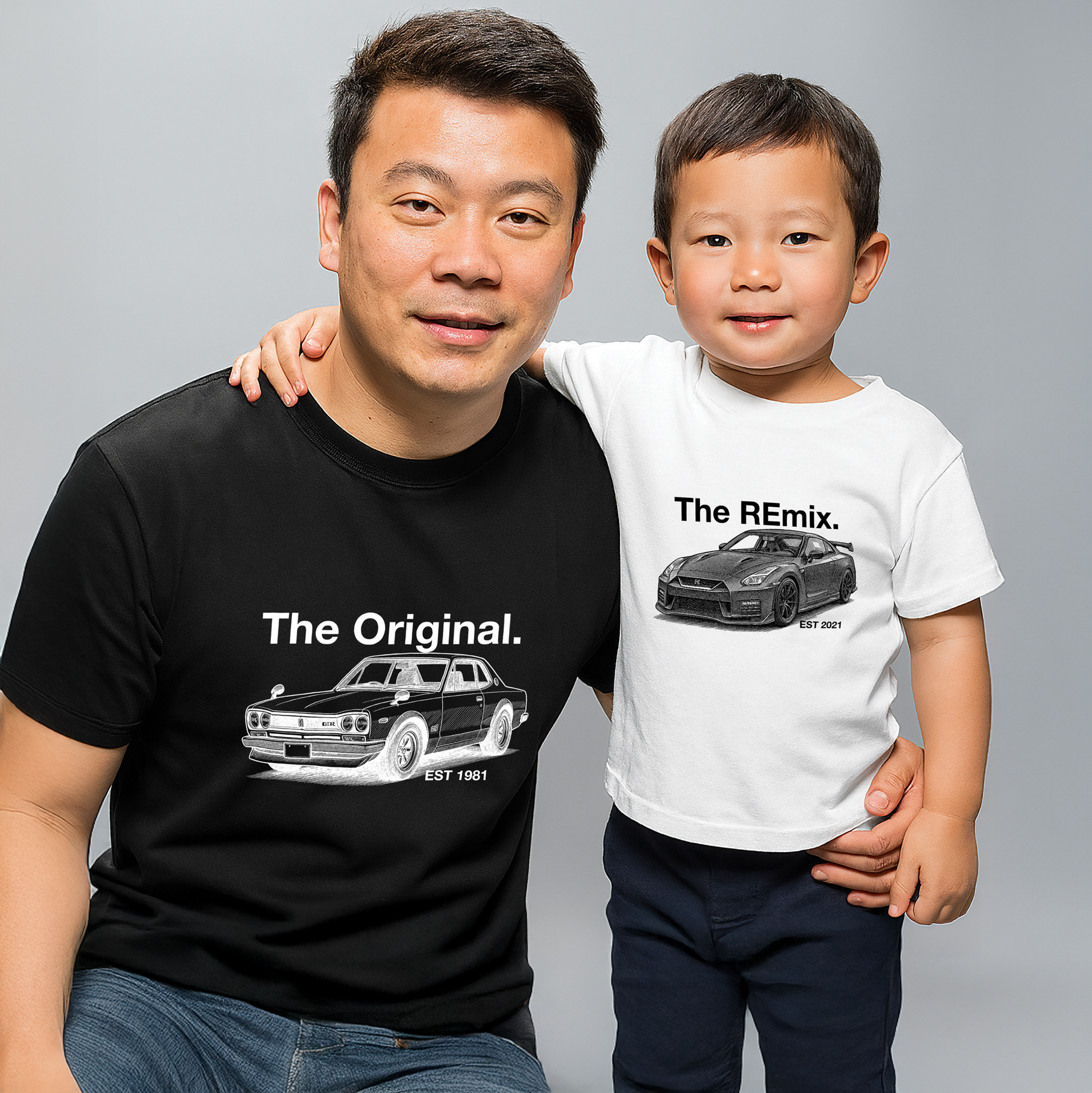 Dad and toddler son wearing matching car shirts – The Original Hakosuka Skyline and The Remix R35 GT-R design in black and white tees